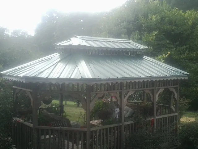 Two tier green metal roof on a garden gazebo in Salem